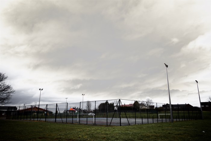 This image is of a tennis court and shows a cloudy sky above.